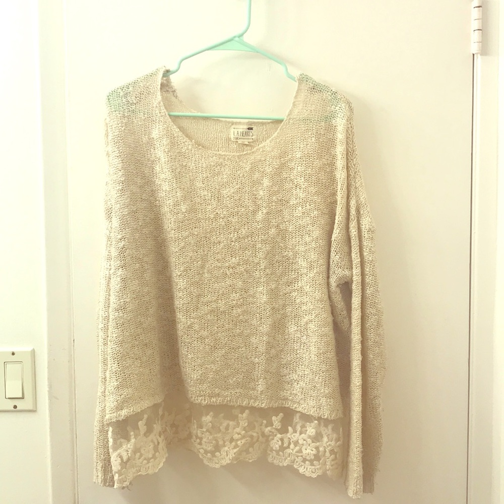 Lightweight sweater with lace detailing at bottom.